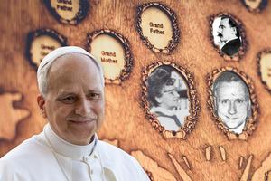 Pope Leo XIV along with photos of his grandfather, mother and father in the background. 