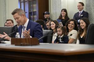 With his family sitting behind him, current Transportation Secretary Sean Duffy testifies before the Senate Commerce, Science, and Transportation Committee on Capitol Hill in Washington, Jan. 15, 2025, for his nomination. 
