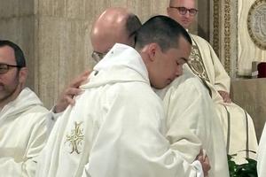 Father Basil Burroughs, newly ordained by Archbishop Anthony Fisher of Sydney, embraces the writer — who baptized and confirmed him a decade earlier — moments after being vested with the priestly stole and chasuble during the June 4 ordination Mass.