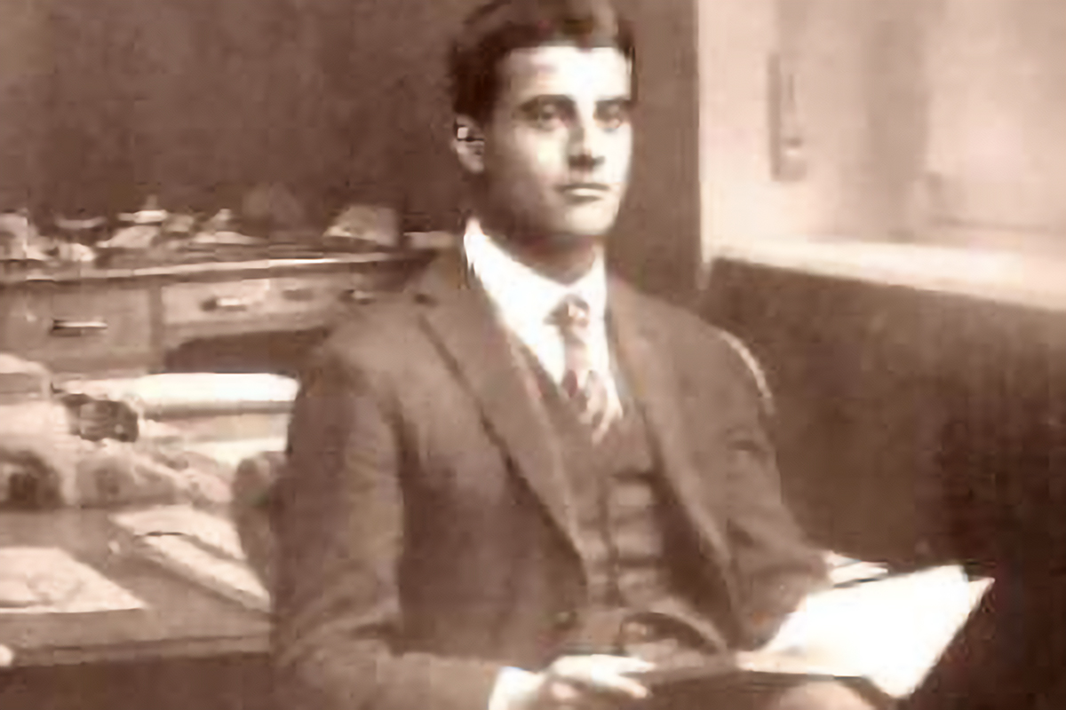 Pier Giorgio Frassati holds a book in his father’s office in 1920.