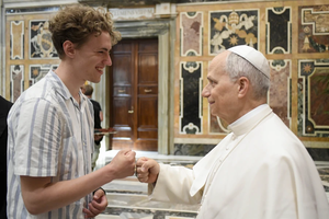 Pope Leo XIV greets a young pilgrim with a fist bump in Rome during a meeting with teachers and young people from Denmark, England, Ireland, Scotland and Wales, Saturday, July 5, 2025.