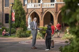 William Thierfelder speaks with students on the campus of Belmont Abbey College.