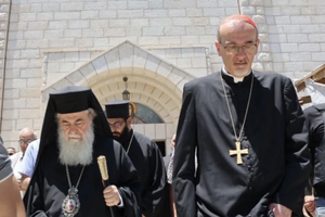 The Latin Patriarch of Jerusalem, Cardinal Pierbattista Pizzaballa, and Greek Orthodox Patriarch Theophilos III, leave the church after a visit to Holy Family Parish in Gaza on July 18, 2025.