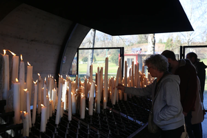 Pilgrims light candles at the Shrine of Our Lady of Lourdes in France.
