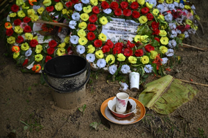 Flowers and offerings are placed at the grave of Ukya Chhaing Marma. The seventh-grader died from his wounds after being rescued from a July 21, 2025, plane crash at his Dhaka school.