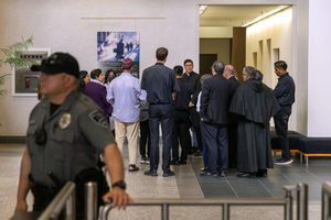 Clergy accompany migrants at a courthouse in San Diego.