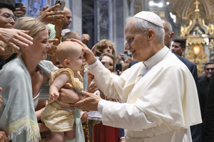 Pope Leo XIV blesses a baby during his Wednesday general audience in St. Peter’s Basilica on Aug. 13, 2025, at the Vatican.