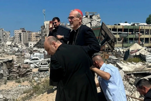 Cardinal Pierbattista Pizzaballa tours the war-torn area surrounding Holy Family Church with the parish’s pastor in Gaza, Father Gabriel Romanelli.