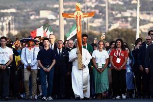 Pope Leo XIV holds the cross as he arrives in Rome's Tor Vergata neighborhood Aug. 2 for a prayer vigil as part of the Jubilee of Youth.