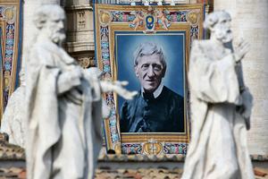 A tapestry of St. John Henry Newman hangs from a balcony overlooking St. Peter’s Square during his Oct. 13, 2019, canonization Mass.