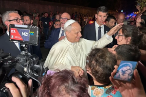 Pope Leo XIV greets the faithful at the gates of Castel Gandolfo on Aug. 19, 2025.