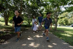 From book clubs to feast-day celebrations, Catholic families like the Fowlers in this Maryland suburb live faithful fellowship with one another and their Christian neighbors. The Fowler kids run, from left to right, Leo (9), Eleanor (4) and John Philip (7); accompanied by their parents, Kate and Adam. 