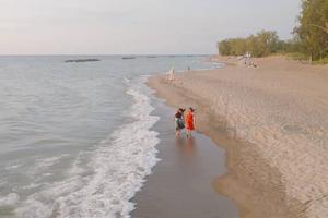 Kate Stapleton strolls the shore of Lake Michigan with her biological daughter, Brigid, in the documentary about their adoption story, ‘The Inner Sea.’