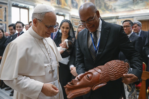 Pope Leo XIV views a gift from an attendee at the International Catholic Legislators Network meeting at the Vatican, Saturday, Aug. 23, 2025.