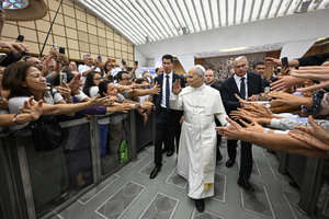 Pilgrims reach out to Pope Leo XIV at the general audience in the Paul VI Audience Hall, Vatican City, Wednesday, Aug. 27, 2025.