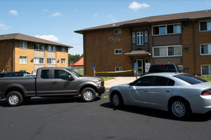 Law enforcement vehicles sit parked outside a reported residence of the shooter following a mass shooting at Annunciation Catholic School on Aug. 27, 2025, in Richfield, Minnesota.