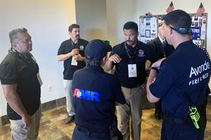 Porters of St. Joseph members work with fire and medical personnel during a security exercise at a suburban Phoenix church.