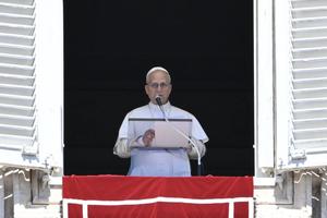 Pope Leo XIV addresses the crowd from the window of the apostolic palace overlooking St.Peter’s Square during his Sunday Angelus prayer at the Vatican on Aug. 31, 2025.         