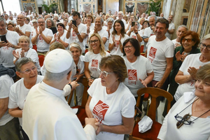 Members of St. Francis' Work for the Poor, wearing t-shirts with the phrase ‘a helping hand to man every day’ with the Holy Father in the Vatican’s Clementine Hall.