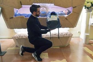A Brazilian priest shows a backpack full of letters from young Brazilians for Blessed Carlo Acutis at his tomb at Santa Maria Maggiore Sanctuary of the Renunciation in Assisi, Italy, on April 23.