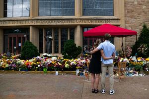 People embrace outside of Annunciation Church and School on September 2, 2025 in Minneapolis, Minnesota. 
