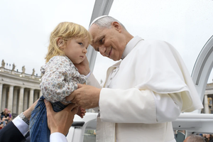 Pope Leo XIV greets a young child before his Wednesday general audience in St. Peter’s Square on Sept. 10, 2025.