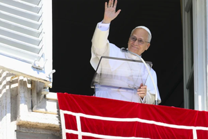 Pope Leo XIV waves to those gathered in St. Peter's Square to pray the Angelus and listen to his Sunday message on Sept. 21, 2025. 