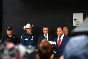 Dallas Mayor Eric Johnson (right) speaks during a press conference following a shooting at a U.S. Immigration and Customs Enforcement (ICE) detention facility in Dallas on Sept. 24, 2025. A detainee was killed and two were wounded in a sniper attack Wednesday on an ICE facility in Dallas, officials said. 