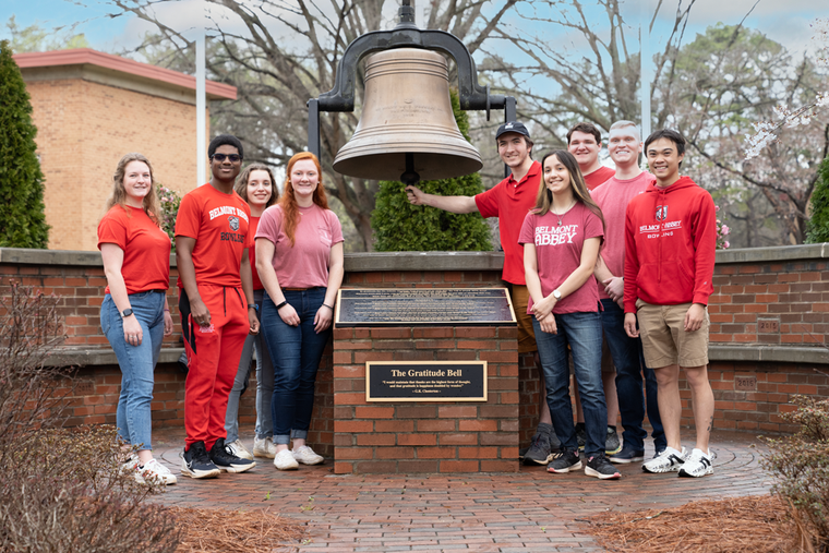 Students gather around the Gratitude Bell at Belmont Abbey College.