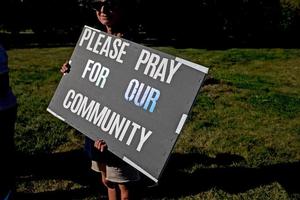 Nurses who are on strike hold signs in support of the community following a shooting and fire at the Church of Jesus Christ of Latter-day Saints in front of Henry Ford Genesys Hospital on September 29, 2025 in Grand Blanc, Michigan. 