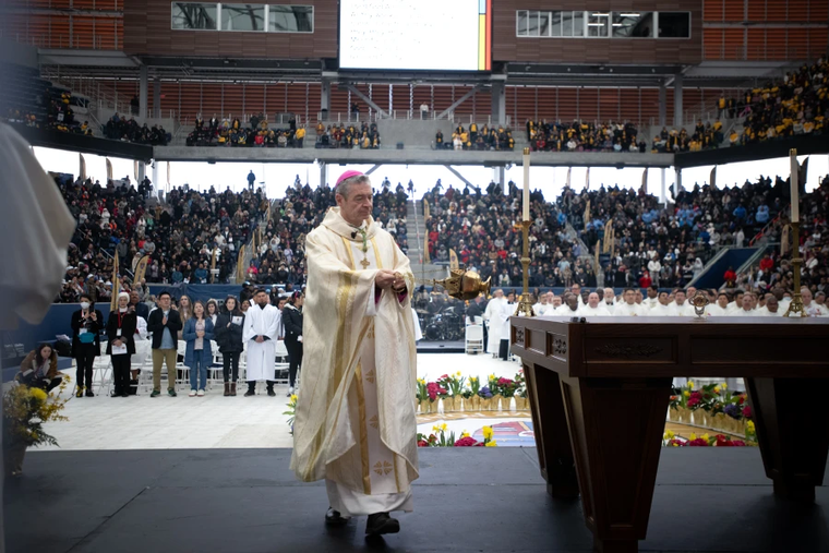 Brooklyn Bishop Robert Brennan carries the thurible around the altar inside Louis Armstrong Stadium on April 20, 2024.