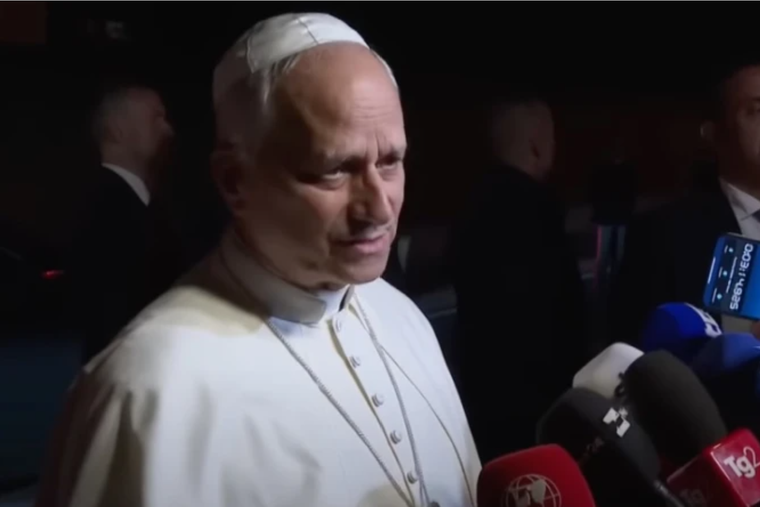 Pope Leo XIV answers questions during an impromptu Q&A with journalists outside Castel Gandolfo on Sept. 30, 2025. 