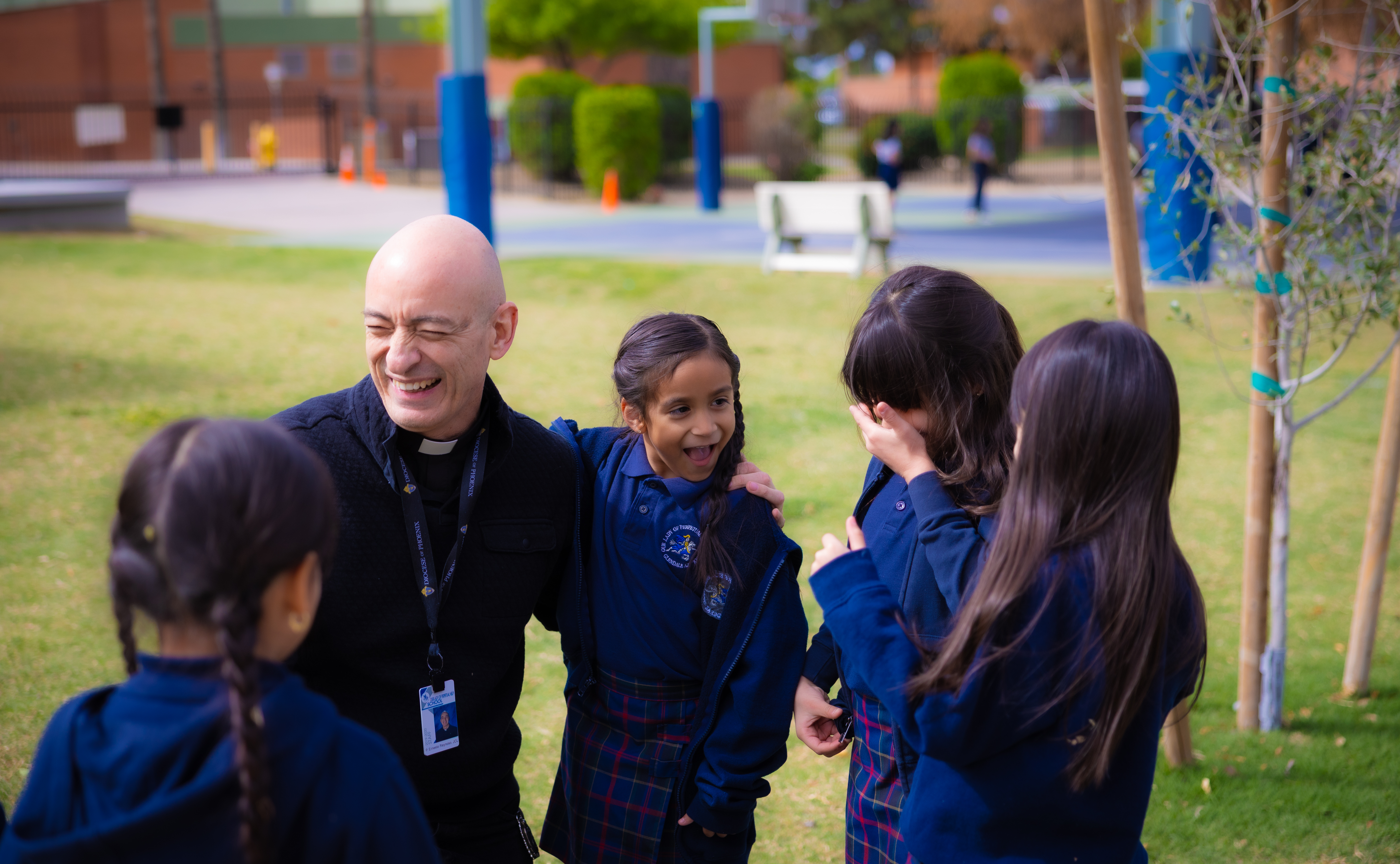 Father Ernesto Reynoso introduces Ben Ben to a student on the campus of Our Lady of Perpetual Help in Glendale, Ariz.