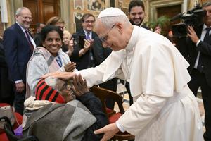 Pope Leo XIV greets an elderly woman at the Vatican on Oct. 3, 2025. 