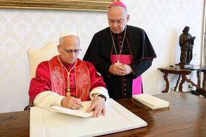 Pope Leo XIV signs his first apostolic exhortation at the Vatican, Saturday, Oct. 4, 2025.
