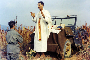 Father Emil Kapaun celebrates Mass using the hood of a Jeep as his altar on Oct. 7, 1950. 