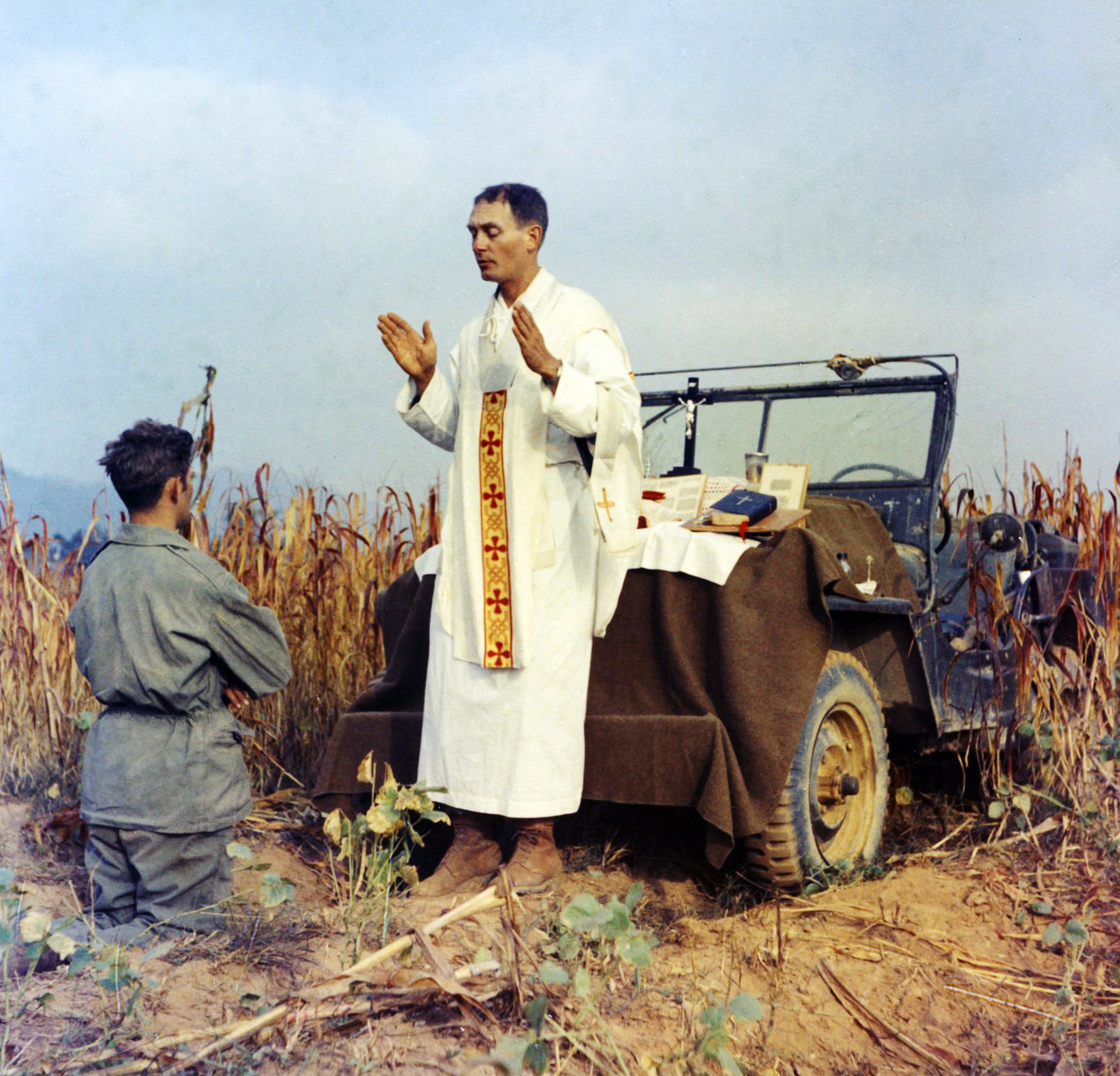 Father Emil Kapaun celebrates Mass using the hood of a Jeep as his altar on Oct. 7, 1950.