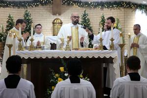 Father Ryan Rojo, the vocations director for the Diocese of San Angelo, Texas, prays over the Eucharist at the diaconate ordination Mass for Mauricio Romero at Holy Redeemer Parish in Odessa, Texas, Dec. 14, 2024.
