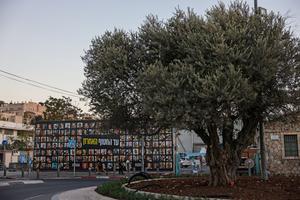 In Jerusalem, on Oct. 6, 2025, people go past a billboard bearing the portraits of Israelis held hostage in the Gaza Strip since 2023.
