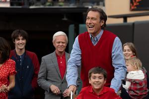 The inspiring story of young John O’Leary (played by James McCracken), supported by his father Denny (portrayed by John Corbett), is told on the big screen in ‘Soul on Fire.’ William H. Macy, seen in the background, also stars.