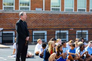 Bishop Michael Burbidge prays the Rosary alongside students at St. Thomas More Cathedral School in Arlington, Virginia.