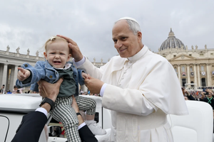 Pope Leo XIV greets a baby during his general audience in St. Peter’s Square at the Vatican on Wednesday, Oct. 22, 2025