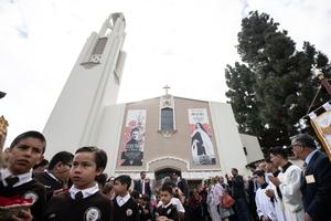 At the Carmelite chapel in Alhambra, banners stretched across the church façade proclaim her message. Children in school uniforms scattered rose petals along the path as priests and sisters processed forward. The arrival was joyful yet hushed, as if heaven itself had bent low to listen.