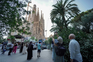 Tourists take photos as they visit the Sagrada Familia basilica in Barcelona, on August 2, 2025.