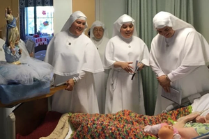The Sister Servants of Mary hold a procession with the statue of Our Lady of the Assumption at Mary Health of the Sick Convalescent Hospital in Newbury Park, California.