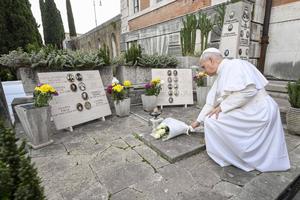 Pope Leo XIV lays flowers at graves, commemorating the faithful departed at Rome's Verano Cemetery, on Nov. 2, 2025. 