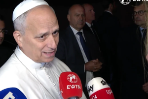 Pope Leo answers questions from journalists as he leaves Castel Gandolfo to return to the Vatican on Nov. 4, 2025.