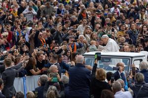 Pope Leo XIV blesses a baby while greeting the faithful his weekly general audience on Oct. 22, 2025 in Vatican Square.