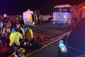First responders provide aid after a bus carrying a group of mostly teenagers from Our Lady of Guadalupe Catholic Church in Santa Ana, California, on its way home from a three-day retreat at Camp Nawakwa in the San Bernardino Mountains crashed on a two-lane highway near Running Springs on Nov. 9, 2025.
