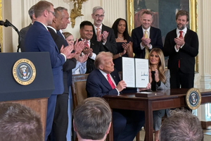 President Donald Trump signs an executive order related to foster care and foster parents on Nov. 13, 2025.